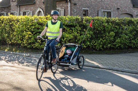 fietser met fietskar waar kind in zit